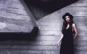 Robe noire fille, chapeau, mur